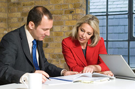 Businessman and businesswoman looking at documents together